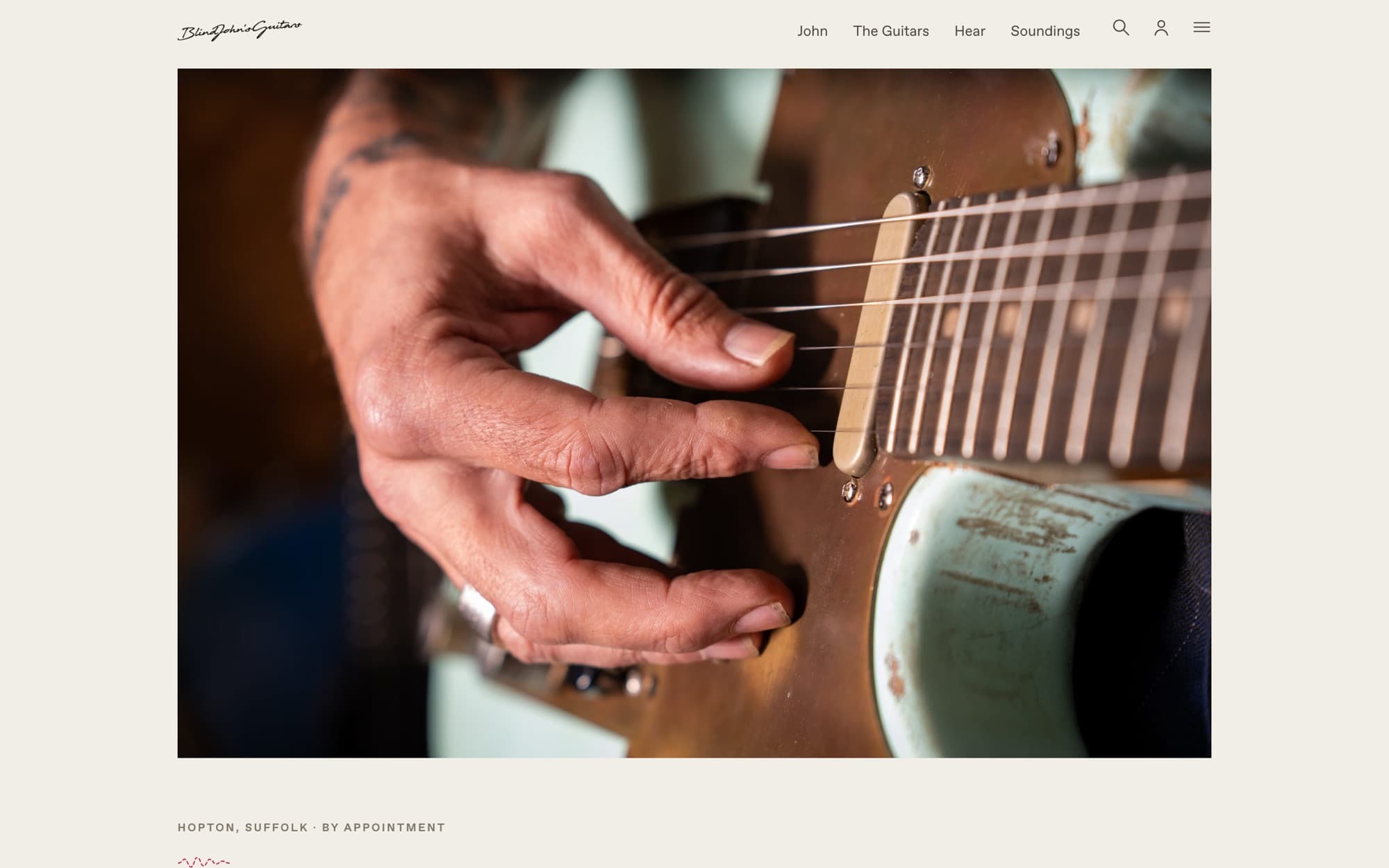 The Blind John's Guitars homepage on desktop: the wordmark, the navigation and a close photograph of John's hand on the Runaway
