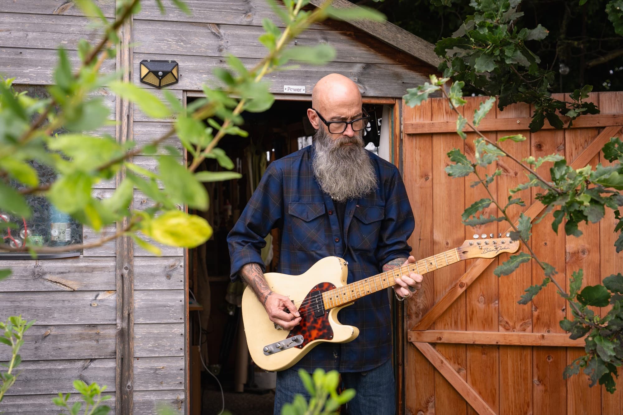 John playing a vintage white Esquire in the doorway of his shed in Suffolk