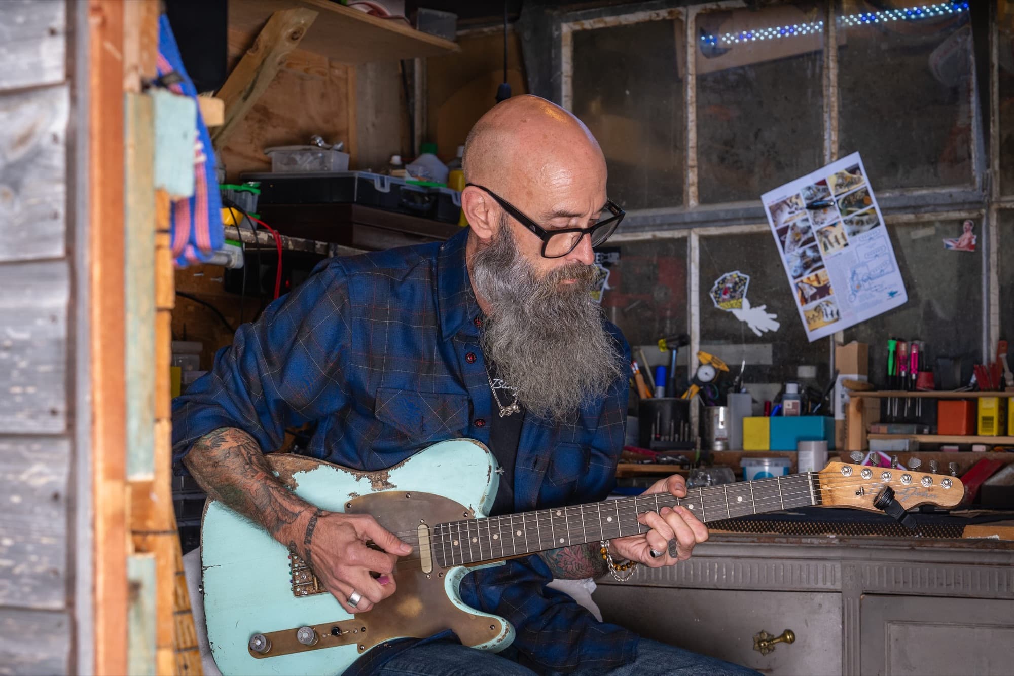 John playing the Runaway, a pale green relic Tele, by the shed window